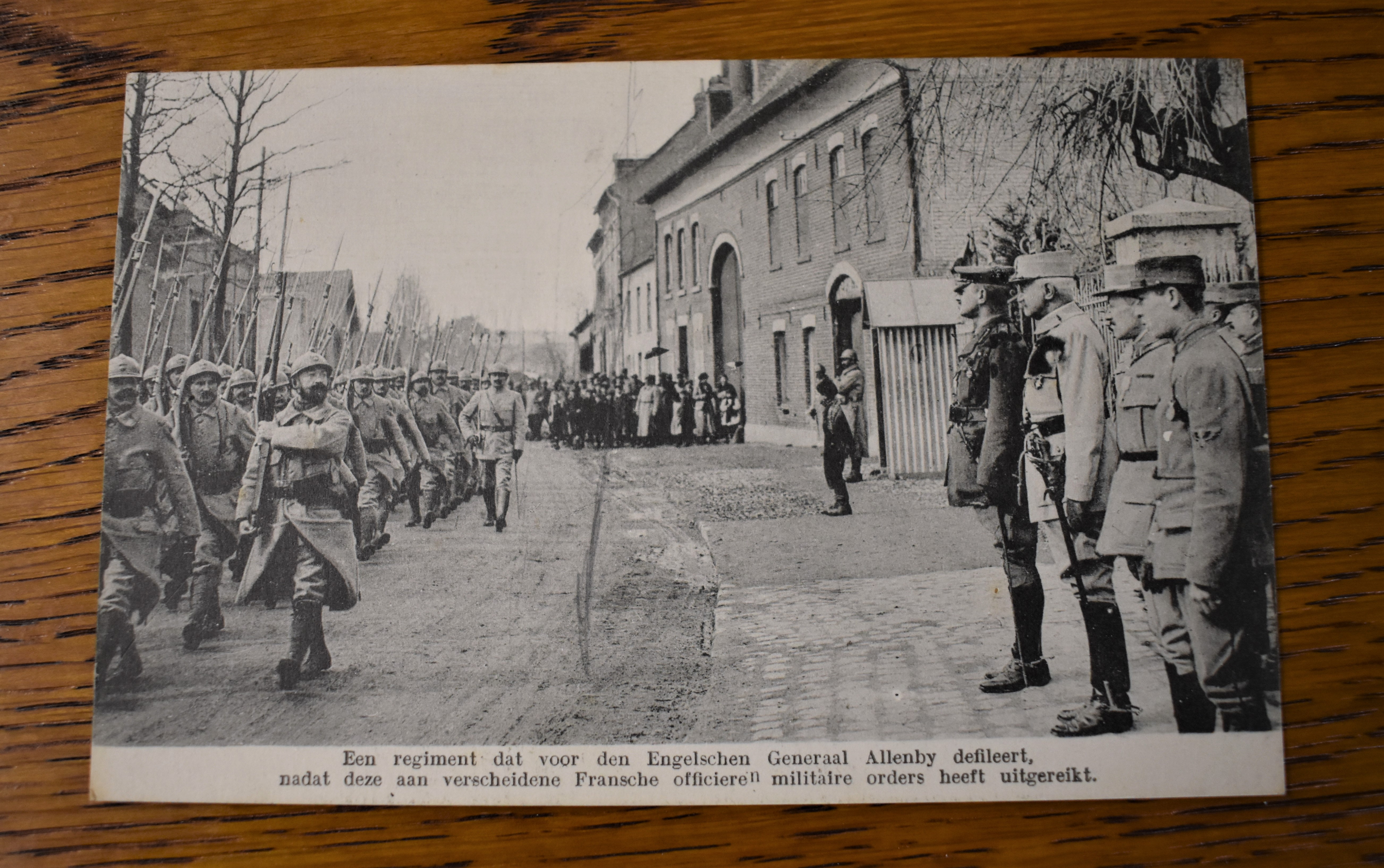 French WWI RP Postcard of a French Regiment marching through a town heading to the front, General