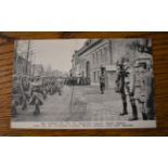 French WWI RP Postcard of a French Regiment marching through a town heading to the front, General