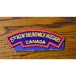 Canadian 8th New Brunswick Hussars Cloth Shoulder Title, red and yellow cord on blue backing.