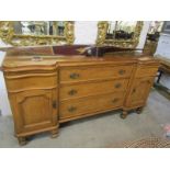CONTINENTAL PINE SIDEBOARD, twin cupboard base flanking triple drawer centre, shaped front pine
