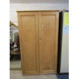 PINE TWIN DOOR STORAGE CABINET, fitted shelves, 73" height 43" width