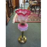 CRANBERRY GLASS OIL LAMP, brass column support oil lamp with pink glass reservoir and cranberry