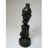 ETHNIC BRONZE, a comical seated naked figure on round base, possibly shine origin, 5" height