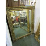 GILT WALL MIRROR, rectangular wall mirror with ornate moulded floral bouquet decoration, 41"