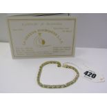 18ct YELLOW GOLD PERIDOT & DIAMOND LINE BRACELET, approx 29 well matched oval cut peridot stones,