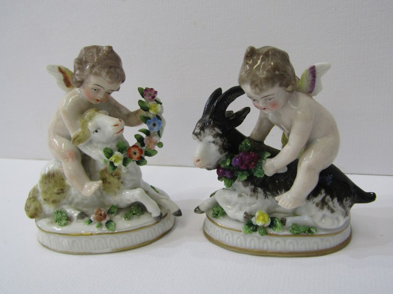 CONTINENTAL PORCELAIN, pair of gilt oval base figures of cherubs riding sheep and goat, 2.5" height