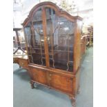 WALNUT VENEERED DISPLAY CABINET, of domed form with 2 glass doors enclosing 2 adjustable shelves