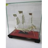 ORIENTAL MODEL, cabinet cased model of Sampan in white metal, cabinet height 11"
