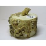 ANTIQUE IVORY, a circular lidded box decorated with engraved and carved relief wild animals,