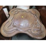 CARVED FOLDING TABLE, the carved top decorated with a serpent, 22"