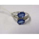 18ct WHITE GOLD TANZANITE & DIAMOND BYPASS RING, 2 well matched oval cut triple A tanzanites, each