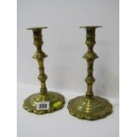 18TH CENTURY BRASS CANDLESTICKS, a pair of petal based brass candlesticks, 8" high