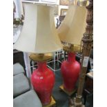LIGHTING, an impressive pair of red painted baluster vase floor lamps, gilt brass fittings with