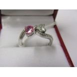 18ct WHITE GOLD DIAMOND & PINK SAPPHIRE HEART BYPASS RING, An unusual apposing hearts, the diamond