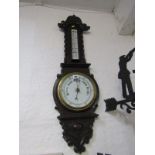 ANEROID BAROMETER, Edwardian carved oak surround barometer with inset thermometer with barley