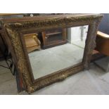 GILT MIRROR, ornate gilt relief framed rectangular wall mirror, 31" height 38" width