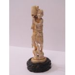 ANTIQUE IVORY FIGURE, Fisherman with trident and basket on carved wooden base