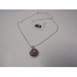 UNUSUAL 18CT WHITE GOLD RUBY & DIAMOND SWIRL PENDANT, on 18ct white gold fine belcher link chain,