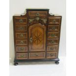 APPRENTICE PIECE, an impressive continental walnut table top cabinet with gilt drop brass handles,