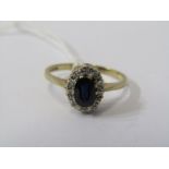 9CT YELLOW GOLD SAPPHIRE & DIAMOND CLUSTER RING, principle dark blue oval cut sapphire surrounded by