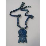 UNUSUAL BLUE STONE PENDANT ON MATCHING CARVED AND FACHETTED NECKLACE