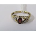 9ct YELLOW GOLD GARNET & DIAMOND RING, principal oval cut garnet in 4 claw setting with accent