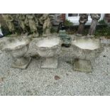 ORNATE PLANTERS, 3 concrete pedestal planters with leaf decoration on square bases 18" diameter