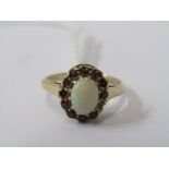 9CT YELLOW GOLD OPAL & GARNET CLUSTER RING, principle oval cut cabachon opal surrounded by brilliant
