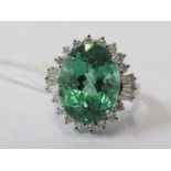 LARGE 18ct WHITE GOLD EMERALD & DIAMOND CLUSTER, Principal oval cut African emerald in excess 7ct,