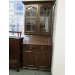 ART NOUVEAU BUREAU/BOOKCASE, leaded twin door glaze top and cupboard base with original oxidised