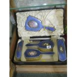 ENAMELLED DRESSING TABLE MIRROR & BRUSH SET, the backs with floral panels in fitted case, retailed