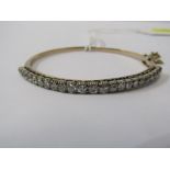 9ct YELLOW GOLD DIAMOND BANGLE, graduated brilliant cut diamonds totalling in excess of 2cts, in 9ct