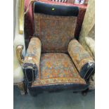 EDWARDIAN CARPET UPHOLSTERED ARMCHAIR, tapering turned legs with original castors