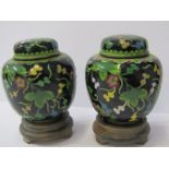 CLOISONNE, pair of Chinese black ground cloisonne lidded ginger jars on carved stands (some faults),