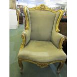 GILTWOOD WING ARMCHAIR, foliate carved arm supports, legs and apron