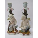 CONTINENTAL PORCELAIN, pair of 19th Century Cupid base candlesticks, underglaze blue crossed scissor