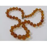 FACETED AMBER BEAD NECKLACE, untested graduated and faceted amber beads, on yellow metal clasp