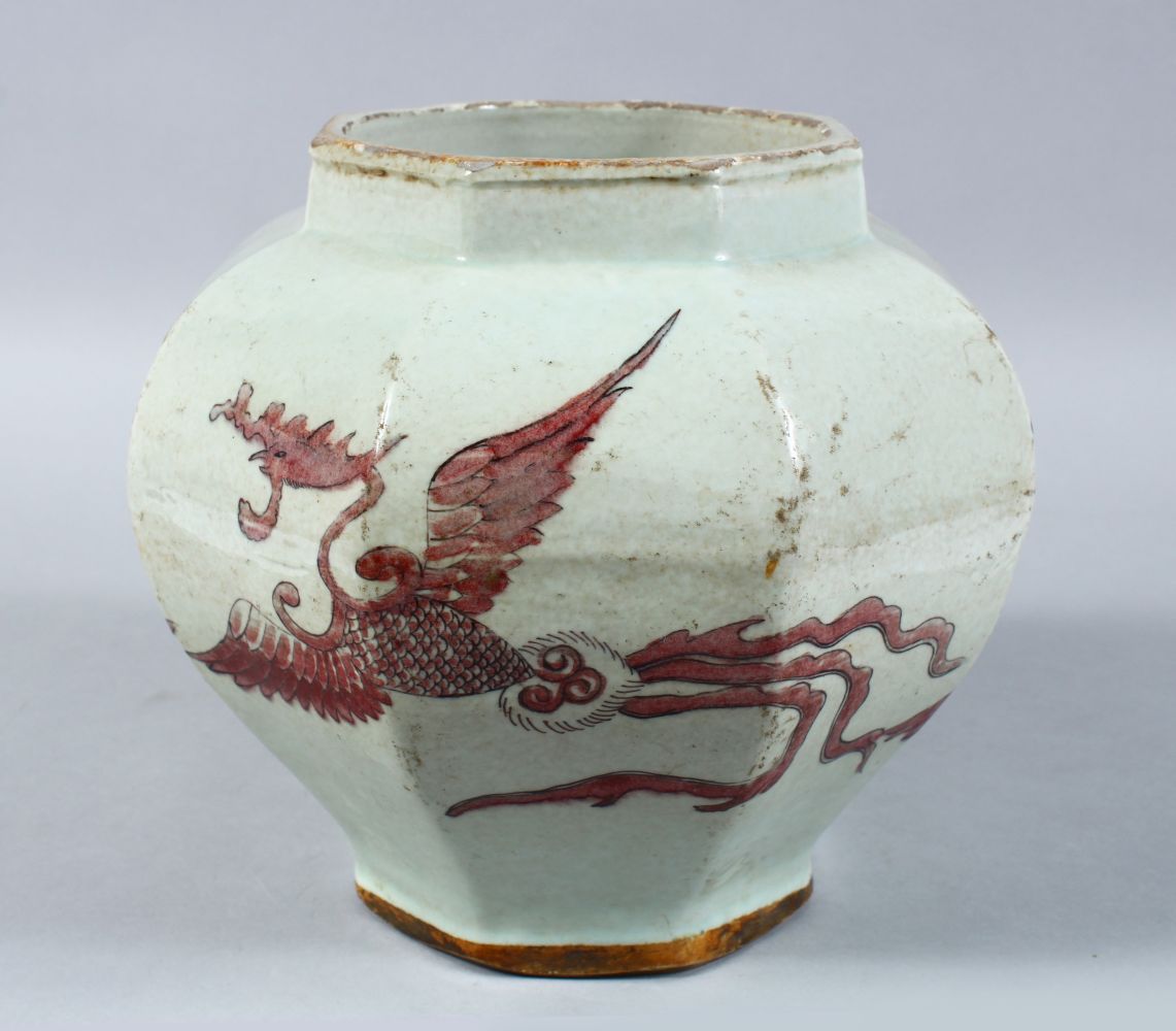 A CHINESE IRON RED DECORATED OCTAGONAL PORCELAIN JAR, the body of the jar decorated in iron red to
