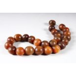 A BEAD NECKLACE, rhino horn, comprising 25 beads, approx 15mm and smaller, weight 55g.