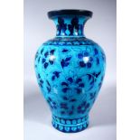 A LARGE INDIAN POTTERY VASE, with turquoise glaze and stylised floral decoration, 42cm high.