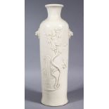 A GOOD CHINESE EARLY 20TH CENTURY DEHUA / BLANC DE CHINE PORCELAIN TWIN HANDLE VASE, the body of the