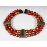 A DOUBLE-ROW BEAD NECKLACE, rhino horn, comprising 48 beads, approx. 15mm and smaller,