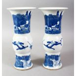 A PAIR OF CHINESE KANGXI STYLE BLUE & WHITE PORCELAIN VASES, the vases decorated with scenes of