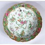 A 19TH CENTURY CHINESE CANTON FAMILLE ROSE PORCELIAN DISH, the dish decorated with displays of