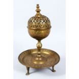 AN EARLY 20TH CENTURY BRASS INCENSE BURNER, with pierced hinged cover, engraved decoration on