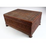 A 19TH CENTURY INDIAN CARVED SANDALWOOD BOX, the cover opening to reveal a removable tray with