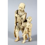 A GOOD JAPANESE MEIJI PERIOD CARVED IVORY FIGURE OF MAN & BOY, the man stood holding a large catch