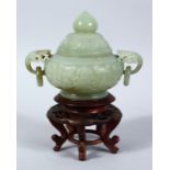 A CHINESE CARVED CELADON JADE LIDDED CENSER & STAND, the censer with carved lion mas handles and