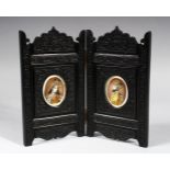 A PAIR OF INDIAN OVAL PORTRAIT MINIATURES OF A MAN AND A WOMAN, in a carved ebony folding frame,