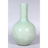 A GOOD CHINESE CRACKLE GLAZED CELADON GROUND PORCELAIN BOTTLE VASE, 26cm high.